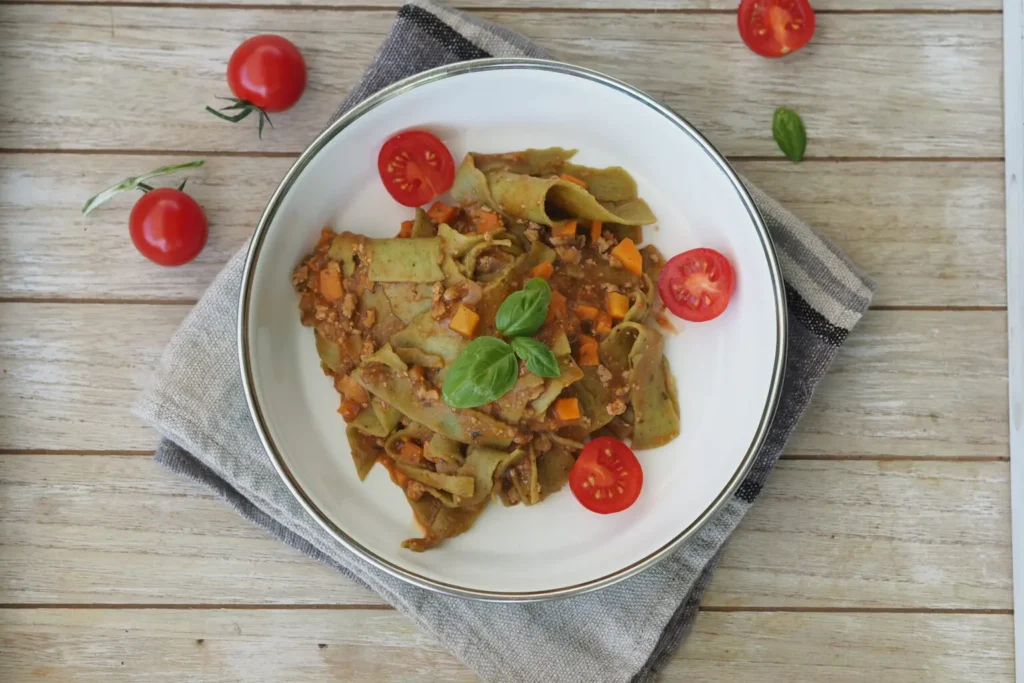 lasagne-gruen-nudeln-tomaten-teller-weiss-serviette-grau